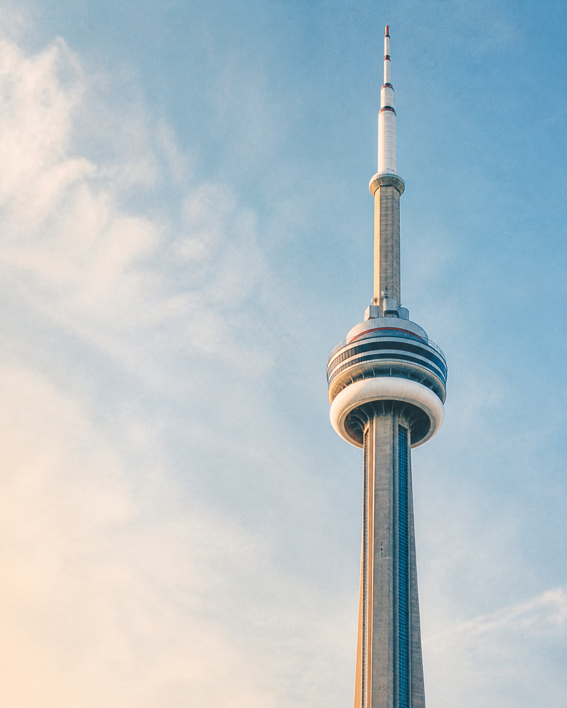 CN Tower in Toronto against a pale blue sky